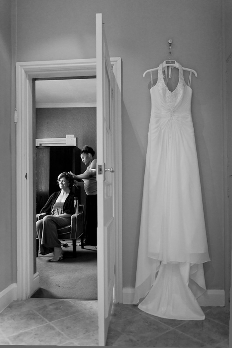 Wedding dress as bride as her hair styled