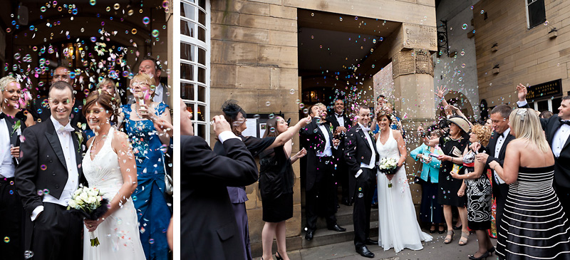 Bride and Groom showered with bubbles from guests
