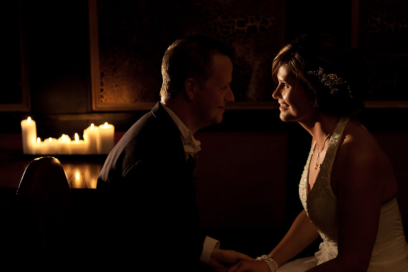 Bride and Groom candlelit looking into each others eyes