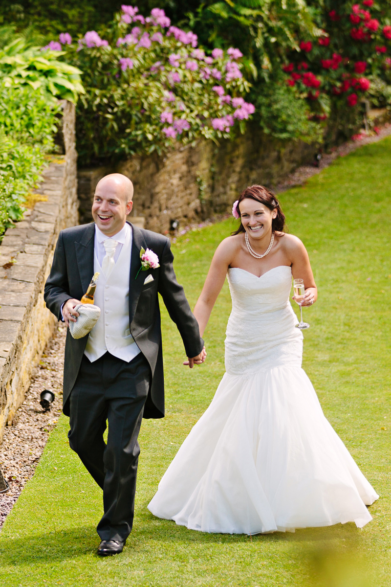 Bride and Groom walking and drinking champagne