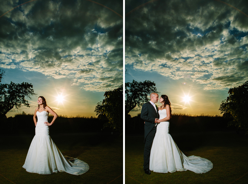 Bride and Groom hold hands while the sun sets behind them