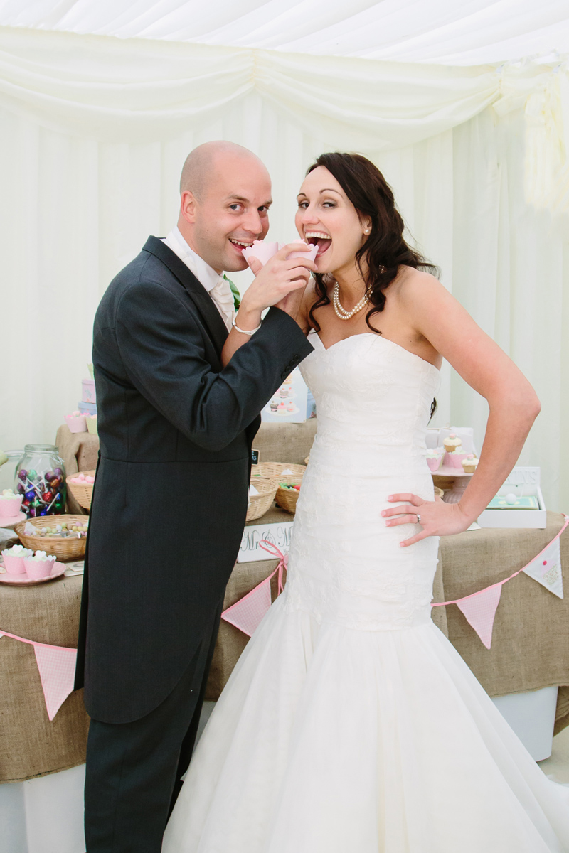 Bride and Groom feed each other wedding cake