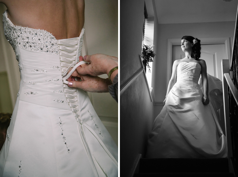 Brides mum fastening her daughters wedding dress 