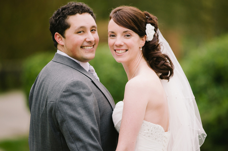 Bride and Groom looking back as they walk hand in hand