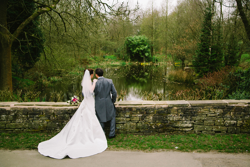 Bride and Groom having a chat while looking over the lake