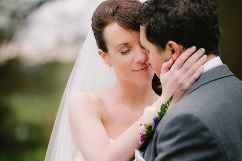 Bride caresses her husband's face