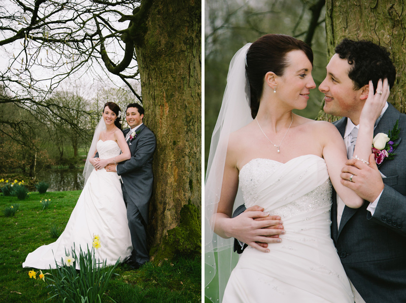 Bride and Groom cuddling by a tree