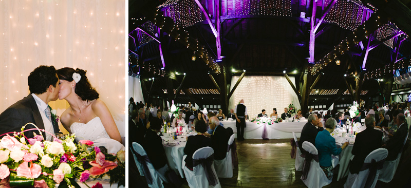 Bride and Groom kiss at wedding breakfast table as the meal is served